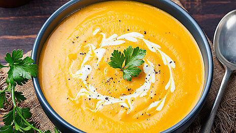 Orange-colored soup with seeds