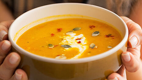 Orange-colored soup with seeds