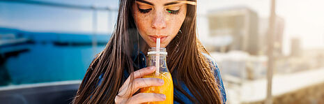 girl drinking orange juice