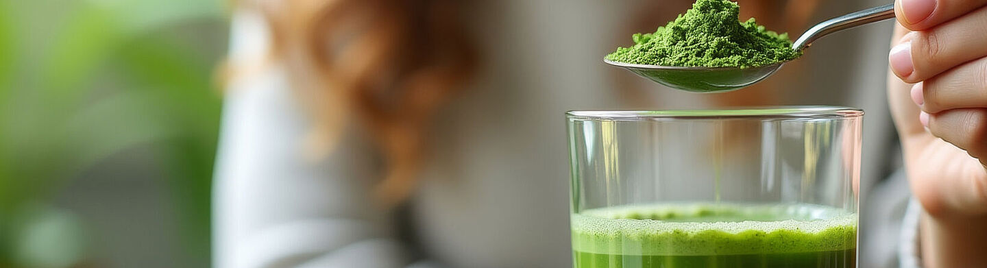 woman with a spoon of green powder