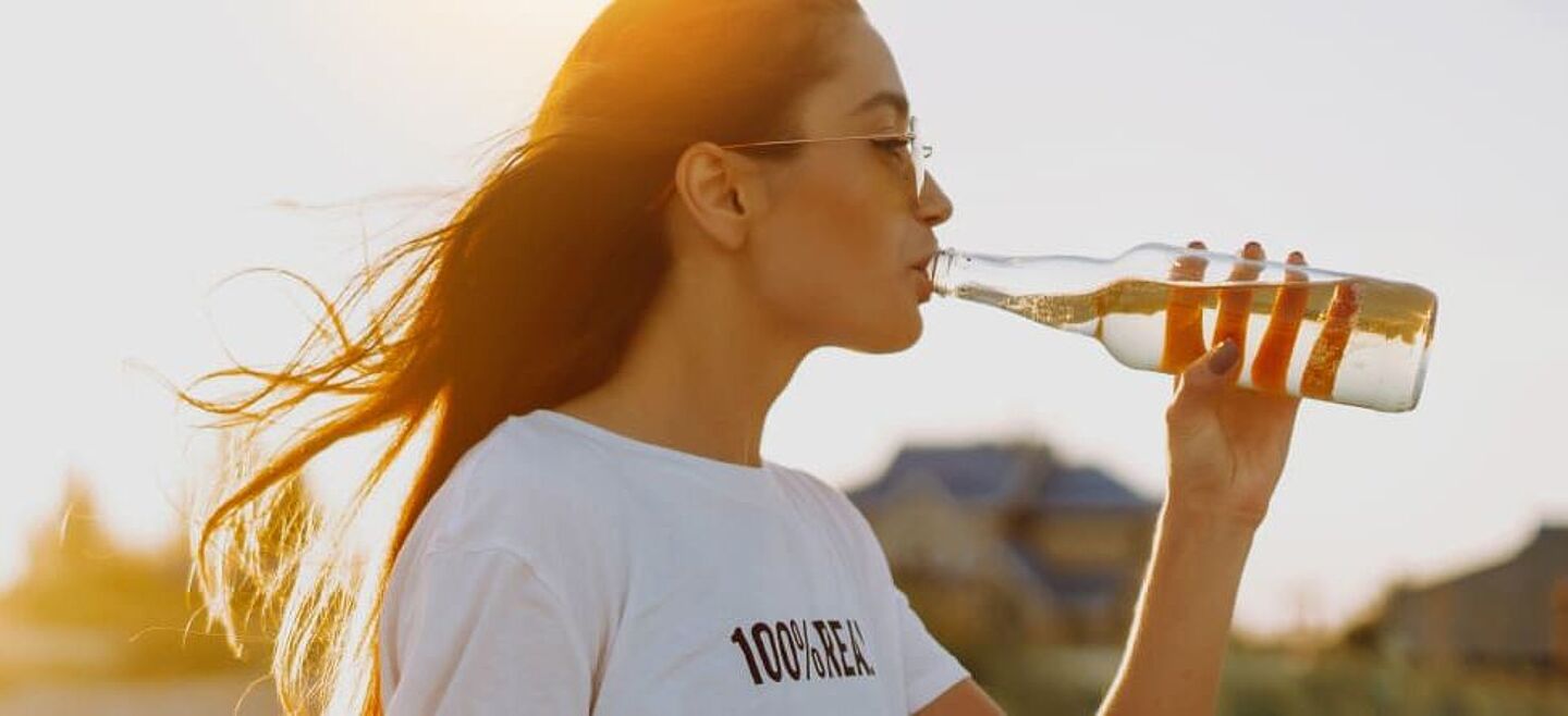 girl with a bottle with herbal drink