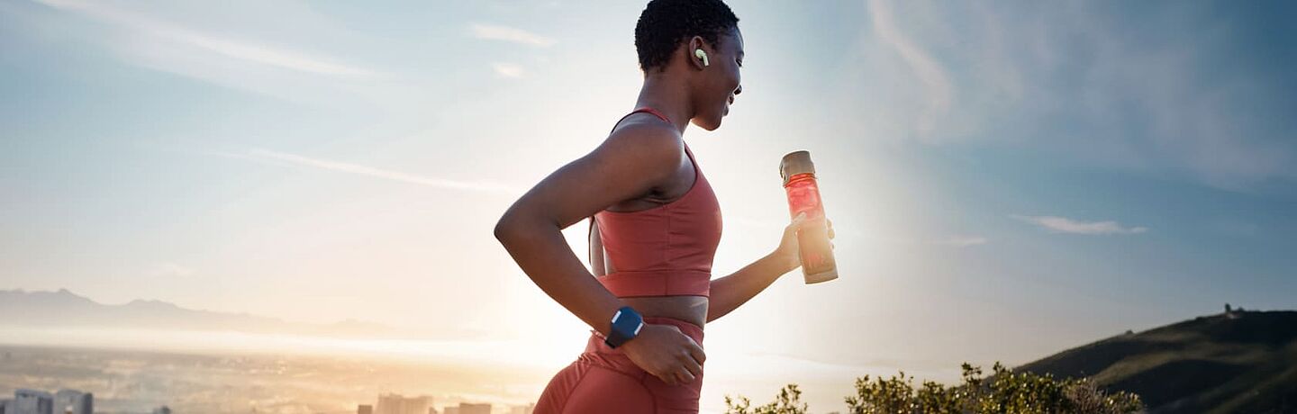 girl running with an energy drink