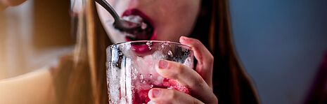 girl eating something with red fruits