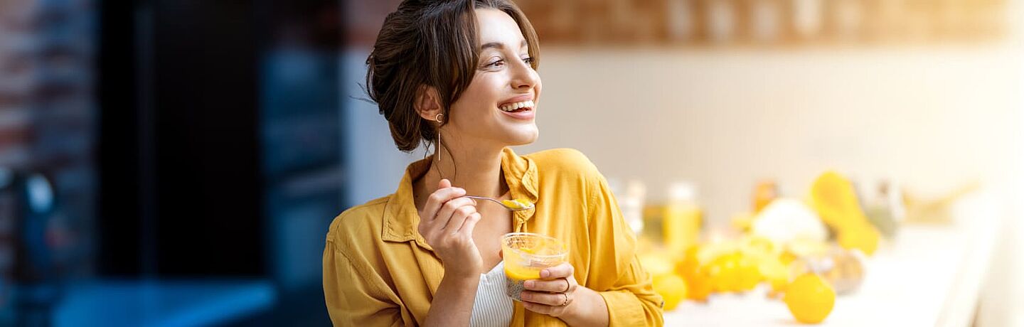 women eating orange fruit preparation