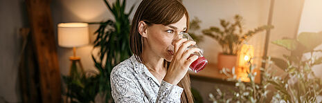 girl drinking a pink juice