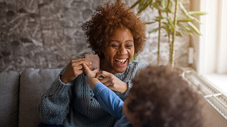A woman and a child are eating chocolate