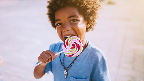 A child is eating a lollipop